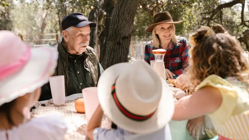 Three generations of a family sitting together at an outdoor table